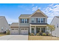Charming two-story home featuring a two-car garage, landscaped yard, and inviting curb appeal at 1062 River Haven Sw Ave, Concord, NC 28025