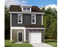 Charming two-story home with stone accents, a gray facade, and a pristine white garage door at 1115 Overbrook Pl, Wingate, NC 28174