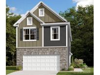 Charming two-story home with mixed siding, brick accents, and an attached two-car garage at 1119 Overbrook Pl, Wingate, NC 28174