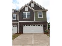 Modern two-story home featuring a two-car garage and a mix of siding and brick exterior finishes at 1119 Overbrook Pl, Wingate, NC 28174
