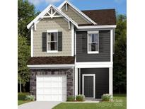 Charming two-story home featuring a mix of stone, shingles, and siding for a modern yet classic curb appeal at 1129 Overbrook Pl, Wingate, NC 28174