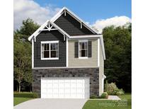 Charming two-story home featuring a stone facade, white garage door, and complementary siding and trim at 1141 Overbrook Pl, Wingate, NC 28174