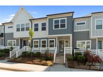 Charming townhome with landscaped front yard, colorful flowers, and inviting entrance at 131 Berkeley Ave # D, Mooresville, NC 28117