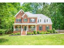 Charming two-story brick home with a welcoming front porch and beautifully landscaped front yard at 141 Culpeze Rd, Mooresville, NC 28117
