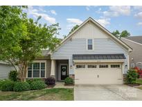 Charming home featuring light blue siding, a two car garage, and a well manicured front yard at 2158 Winhall Rd, Fort Mill, SC 29715