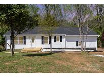 Charming single-story home with white siding, black shutters, and a inviting front porch at 221 Belton Ave, Mount Holly, NC 28120