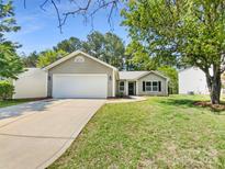 Charming single-story home with a well-maintained lawn, attached garage, and inviting curb appeal at 2512 Captains Watch Ne Rd, Kannapolis, NC 28083