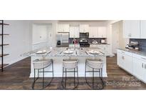 Bright kitchen features white cabinets, stainless steel appliances, granite counters, and an island with seating at 4372 Bronze Blvd, Sherrills Ford, NC 28673