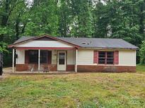 Single story home with a covered front porch and brick base sitting on a large lot at 4406 Valeview Ln, Charlotte, NC 28269