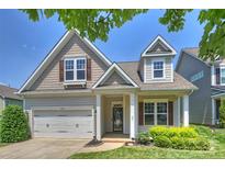 Charming home featuring a two-car garage, covered entryway, and manicured landscaping at 505 Chamberlain Ct, McAdenville, NC 28101