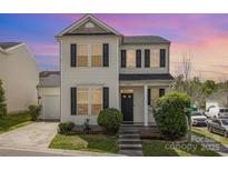 Charming two-story home features manicured lawn, black shutters, and neutral siding on a corner lot at 8424 Spirea Ct, Charlotte, NC 28215