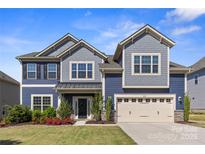 Charming two-story home with manicured lawn, craftsman details, and inviting curb appeal at 8429 Golden Stone Ln, Fort Mill, SC 29707