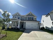 Charming two-story home with a two-car garage, manicured lawn, and classic architectural details at 2020 Embassy Ct # 48, Charlotte, NC 28213
