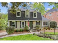 Charming two-story home featuring a classic roofline, neatly manicured lawn, and professionally landscaped front yard at 2418 Ainsdale Rd, Charlotte, NC 28226