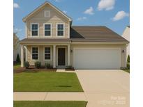 Charming two-story home featuring a spacious two-car garage, well-manicured lawn, and classic architectural details at 3173 Pinehills Way, Mount Holly, NC 28120