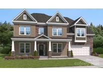 Charming two-story home featuring a brick facade, covered entrance, and well-manicured lawn at 424 Balboa St, Matthews, NC 28104
