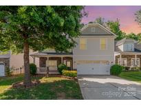 Charming two-story home features a two-car garage, covered front porch, and mature landscaping at 5106 Stone Park Dr, Charlotte, NC 28269