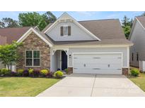 Charming home exterior featuring a stone facade, two-car garage, and well-maintained landscaping at 536 Rustlewood Way, Rock Hill, SC 29732