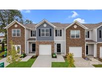 Charming townhome exterior with a brick and siding facade, well-manicured lawn, and private garage at 6161 Helens Rest Ln, Lincolnton, NC 28092
