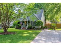 Charming single-story home featuring mature trees, landscaped yard, and inviting front porch at 741 Bermuda Ave, Gastonia, NC 28054