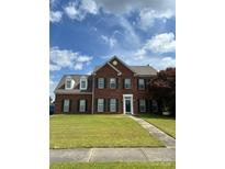 Charming two-story brick home with a well-manicured lawn and inviting entrance at 7505 Conifer Cir, Indian Trail, NC 28079