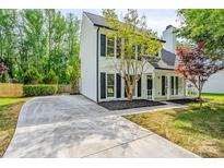 Charming two-story home with black shutters, inviting front porch, and well-manicured lawn at 7810 Trotter Rd, Charlotte, NC 28216