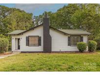 Charming single-story home featuring a black brick chimney and complemented by mature trees at 8 Bolt Dr, Shelby, NC 28150