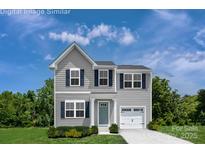 Charming two-story home with gray siding, dark shutters, and an attached one-car garage at 128 Millstream Dr, China Grove, NC 28023