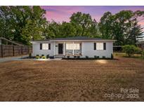 Inviting home featuring manicured landscaping with a fresh, vibrant lawn and mature trees enhancing its charm at 1306 Klondale Ave, Kannapolis, NC 28081