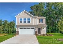 Two story home with beige siding, attached garage, and well-manicured lawn at 2107 Columbidae Ln, Gastonia, NC 28052