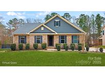 Charming brick home with blue siding and shutters, complemented by lush green lawn and landscaping at 2322 Morrison Rd, York, SC 29745