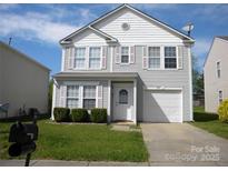 Charming two-story home features a well-maintained lawn, attached garage, and classic architectural details at 391 Morning Dew Dr, Concord, NC 28025