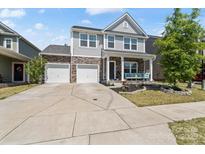 Charming two-story home with stone accents, a well-manicured lawn, and a spacious two-car driveway at 980 Bunker Trce, Rock Hill, SC 29730
