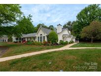 Charming, well-landscaped home with a manicured lawn and a welcoming walkway, perfect for suburban living at 21136 Cold Spring Ln, Cornelius, NC 28031