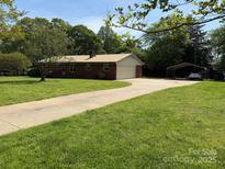 Charming brick home features a long driveway and a spacious, well-manicured front yard at 370 Sherrill Farm Rd, Lincolnton, NC 28092