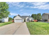 Charming single-story home featuring a two-car garage, well-manicured lawn, and inviting curb appeal at 4606 Falcon Chase Sw Dr, Concord, NC 28027