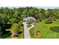 Stunning aerial view of the home with lush landscaping and a circular driveway at 8670 Arbor Oaks Cir, Concord, NC 28027