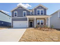 Charming two-story home with a covered porch, two-car garage, and landscaped front yard at 139 Satchel Ct, Mooresville, NC 28115