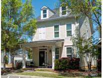Charming two-story home boasts a cozy front porch, well-kept lawn, and inviting curb appeal at 1424 South St, Cornelius, NC 28031