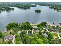Stunning aerial view of lakefront homes surrounded by lush greenery and a serene lake at 166 Wilson Lake Rd, Mooresville, NC 28117