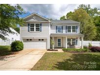 Charming two-story home featuring a well-manicured lawn and inviting front porch, offering great curb appeal at 1965 Leesburg Dr, Clover, SC 29710
