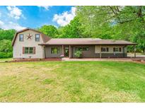 Charming two-story home with a spacious front lawn and metal roof at 286 Bell Farm Rd, Statesville, NC 28625