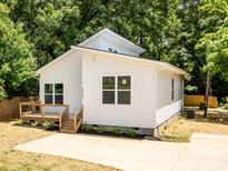 Charming home boasts a modern design, natural light, and a lovely wooden deck at 3007 West Blvd, Charlotte, NC 28208
