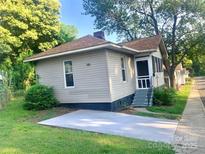 Charming one-story home featuring neutral siding, a screened-in porch, and a well-manicured lawn at 439 17Th St, Cramerton, NC 28032