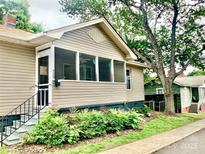 Charming home featuring a cozy screened-in porch and well-maintained landscaping at 439 17Th St, Cramerton, NC 28032