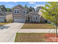 Charming two-story home with a well-manicured lawn and inviting curb appeal on a sunny day at 5024 Colline Ct, Charlotte, NC 28216