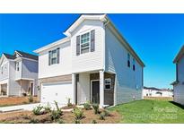 Charming two-story home featuring a brick-accented facade, attached garage, and well-maintained landscaping at 5027 Poplin Vly, Cherryville, NC 28021