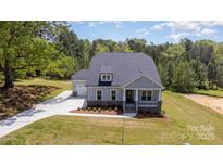 Charming two-story home with stone accents, covered porch, and attached garage at 515 Edmunds Ln # 38, Clover, SC 29710