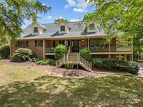 Charming two-story brick home with dormers and a welcoming front porch at 627 S Chapel St, Landis, NC 28088