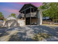 The house features a two-story porch and a patio area with outdoor seating at 120 N Cardinal N Dr, New London, NC 28127